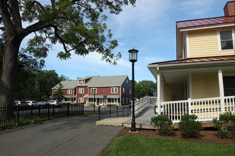 a row of houses in a neighborhood with a street lamp