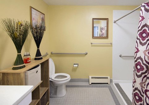 a bathroom with a toilet and a sink and a shower