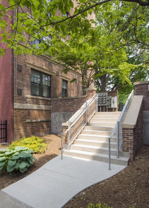 a set of stairs in front of a brick building