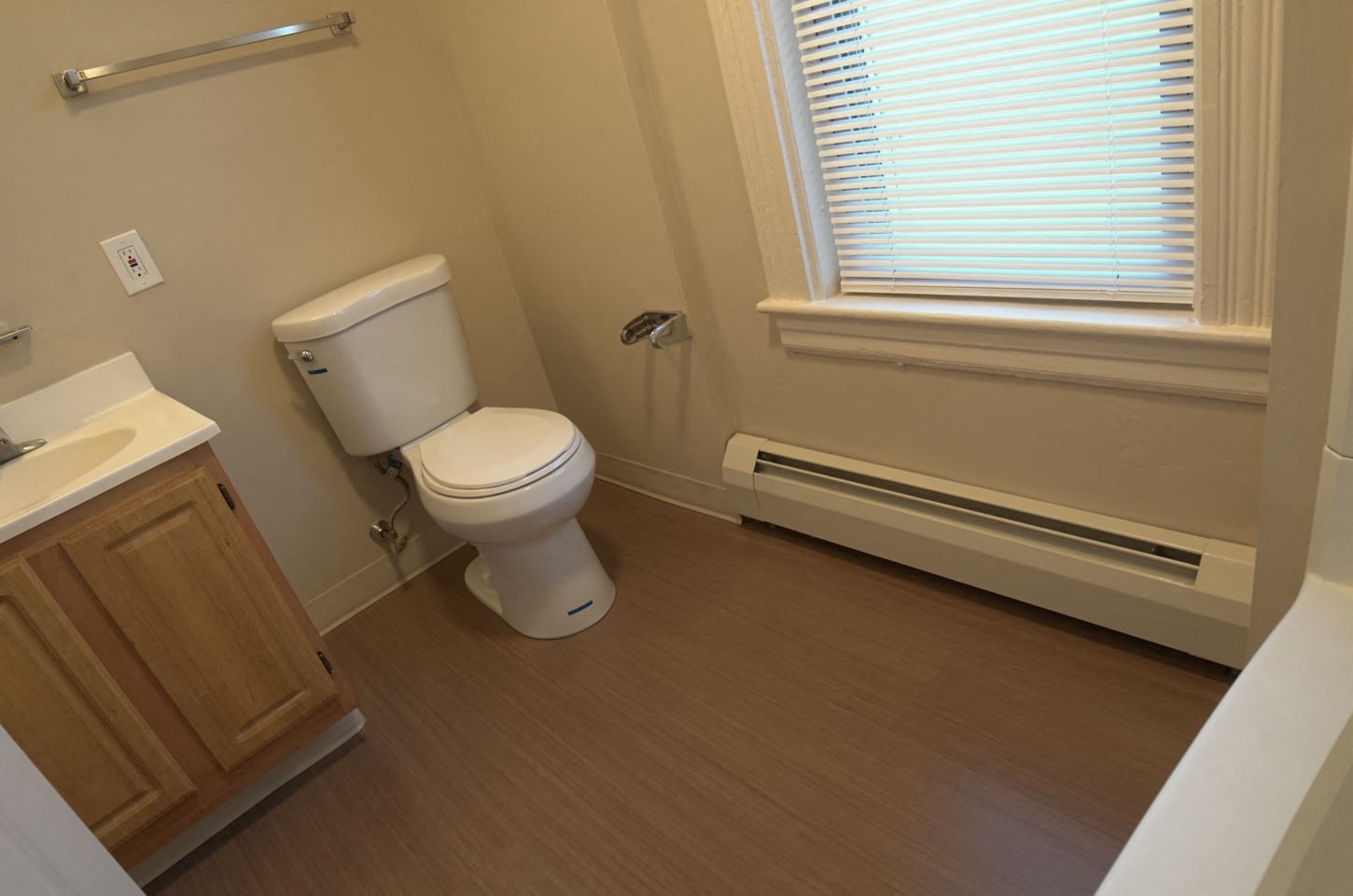 a bathroom with a toilet and a window