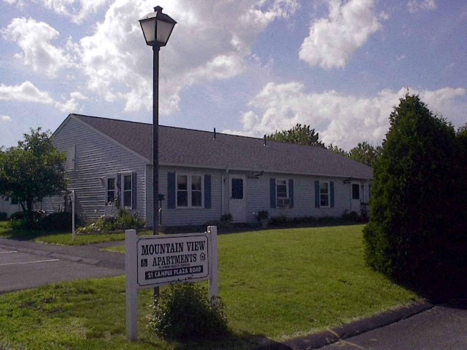 a white house with a sign in front of it