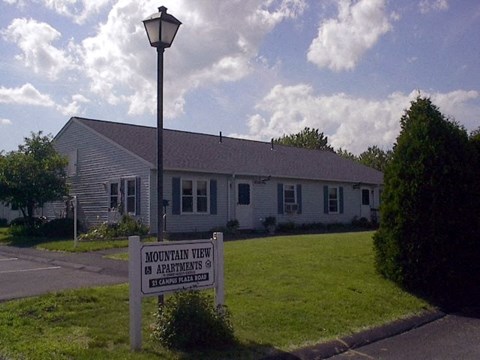 a white house with a sign in front of it