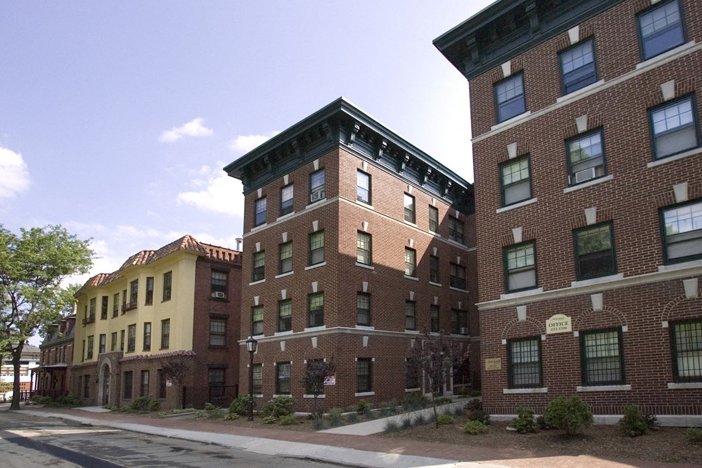 a group of brick apartment buildings on a city street