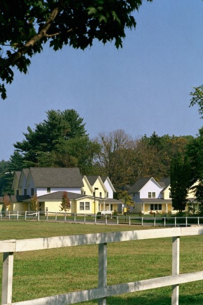 a row of houses in front of a field