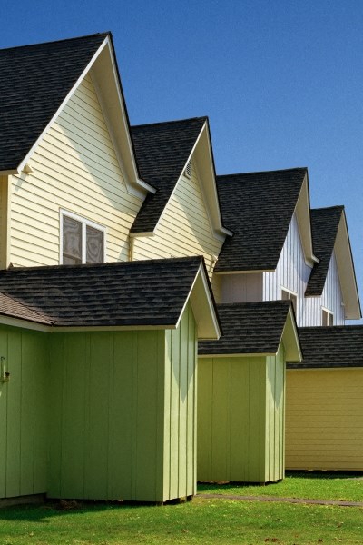 a row of houses with green garages