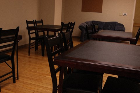 a dining room with tables and chairs and a couch