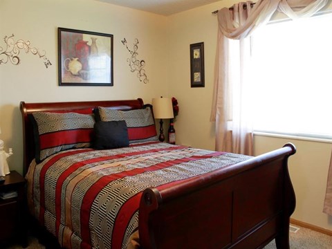 a bedroom with a bed and a window