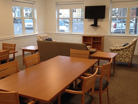 A conference room with a long table and chairs.