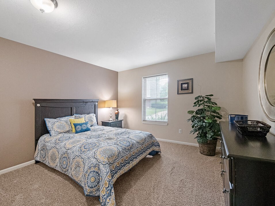 Bedroom with window and overhead light at burwick farms
