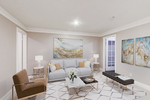 A living room with a grey couch, a brown chair, a coffee table, and a painting on the wall.
