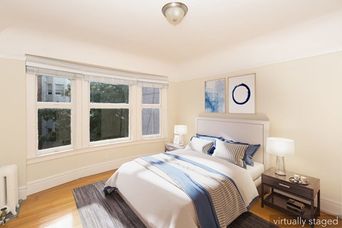 A bedroom with a white bed and blue accents.