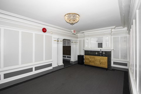 A white room with a fireplace and a chandelier.