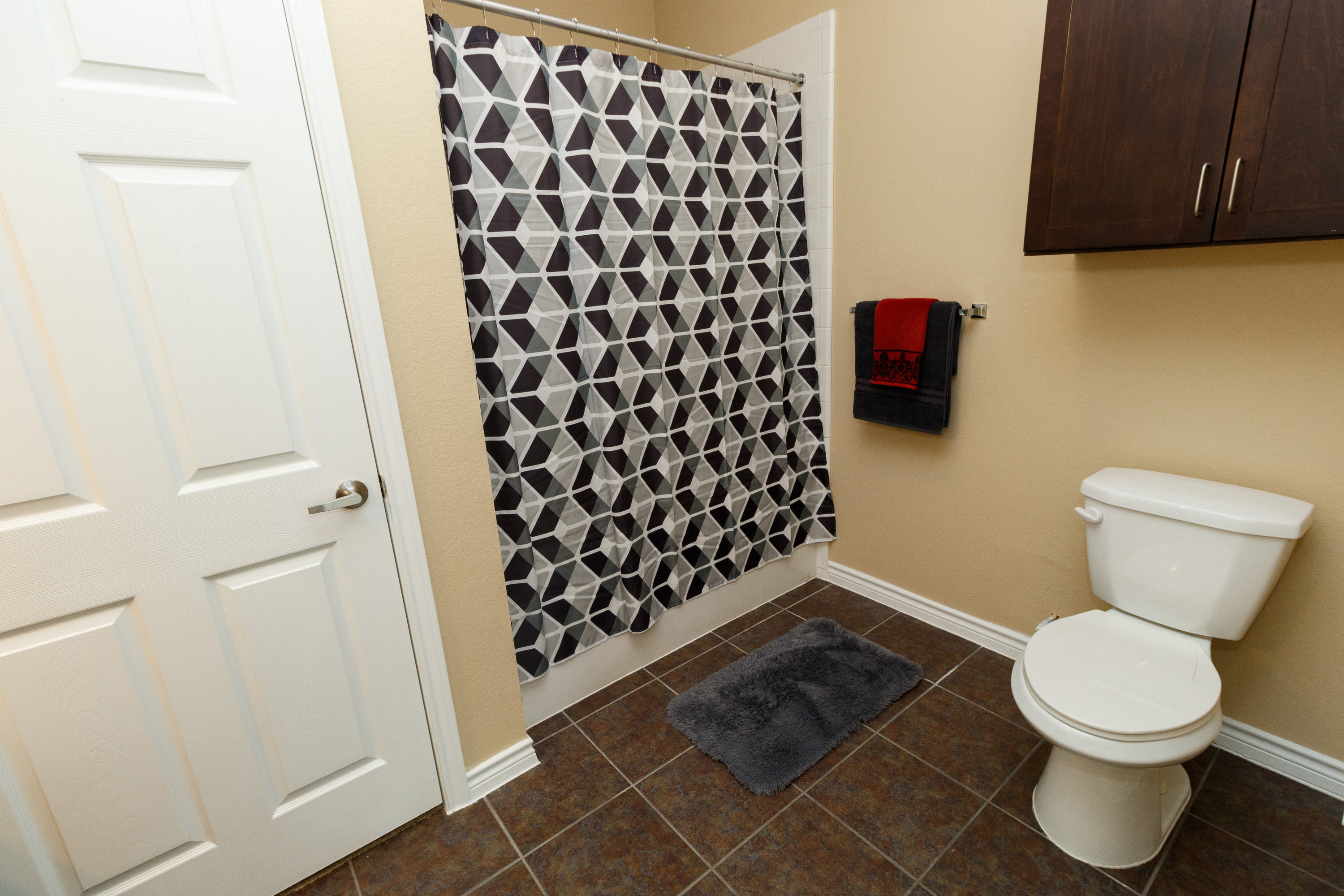 an image of a bathroom with a toilet and a shower curtain