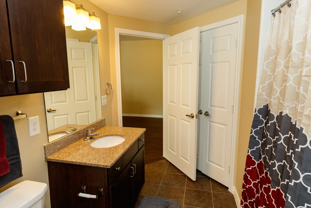 a bathroom with a sink and two doors