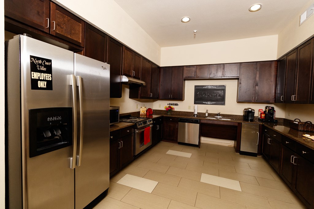 a kitchen with stainless steel appliances and wooden cabinets