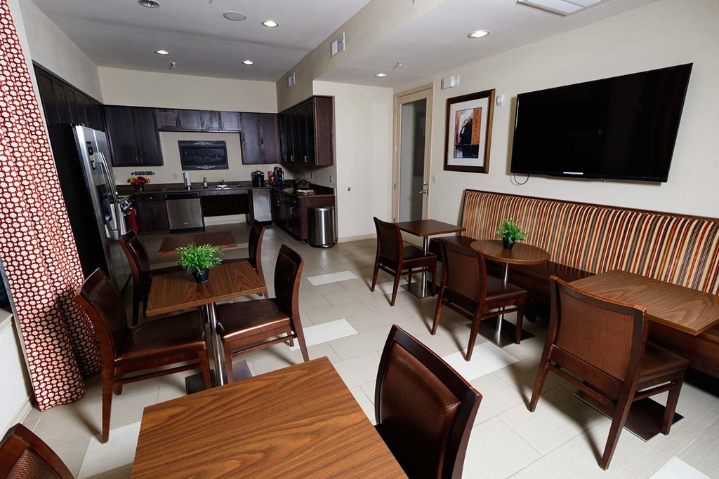 a dining room and kitchen with a table and chairs