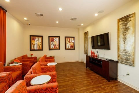 a living room with orange couches and a television