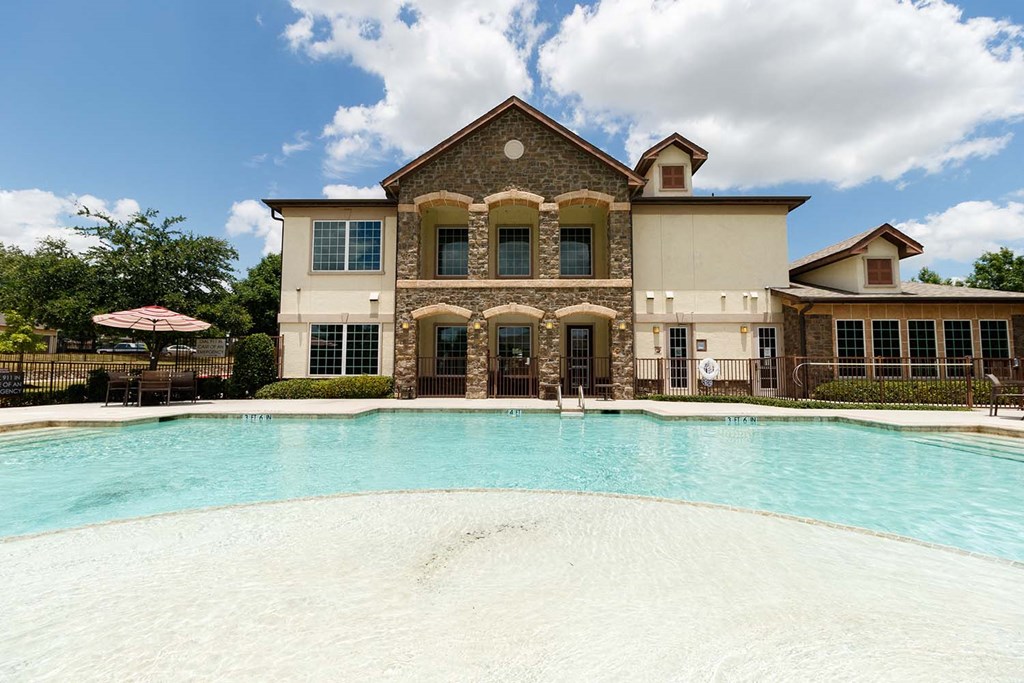 a large swimming pool in front of a building