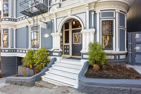 A blue and white building with a black awning.