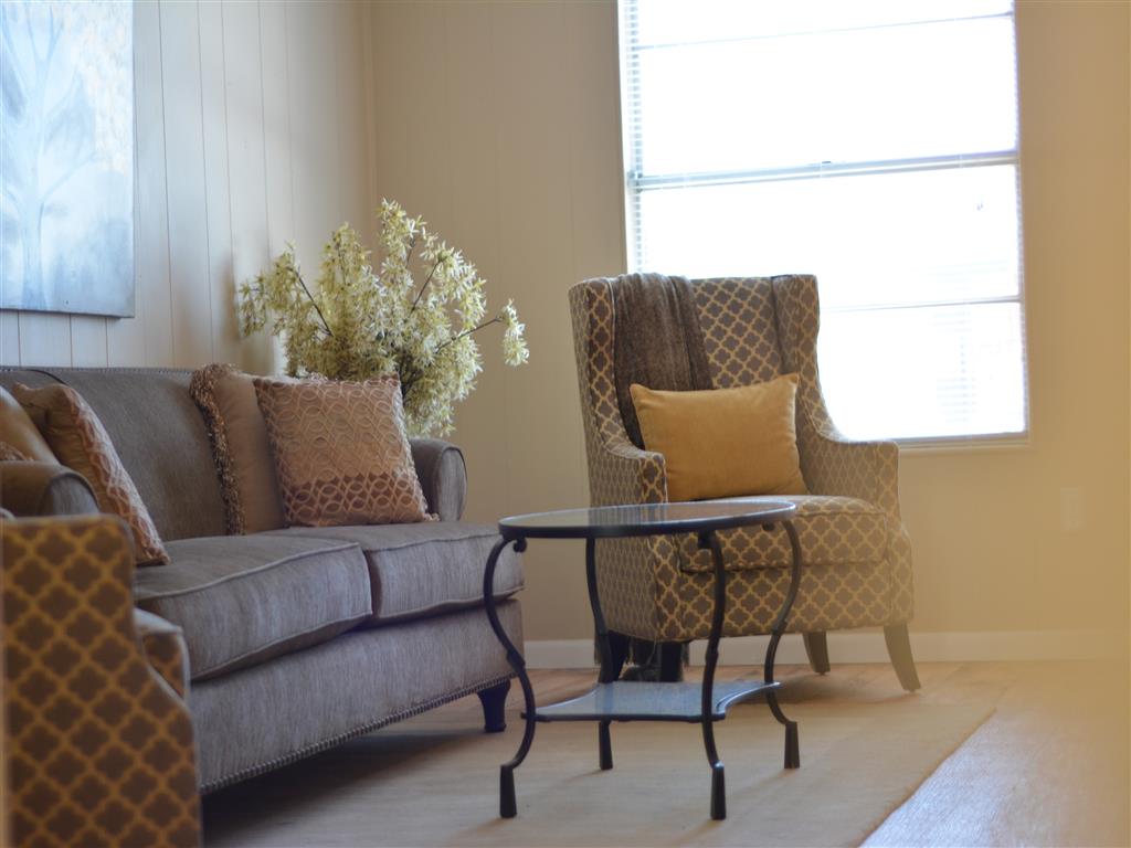 a living room with a couch and chairs and a coffee table