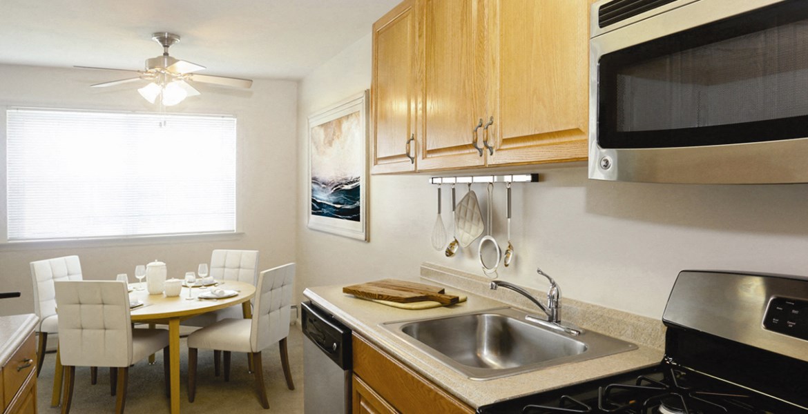 a kitchen and dining room with a sink and a table and chairs