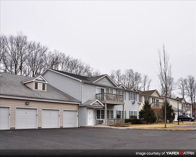 A row of houses with garages in front.