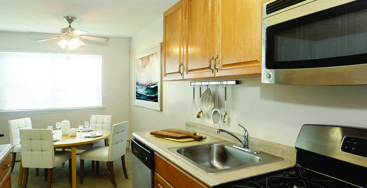 a kitchen and dining room with a sink and a microwave
