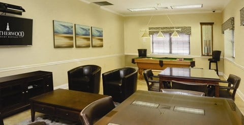 community center with tables and chairs, TV and pool table at Heatherwood House at Patchogue, Patchogue