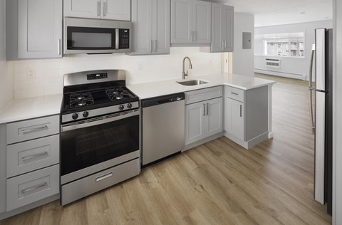 a kitchen with stainless steel appliances and white cabinets