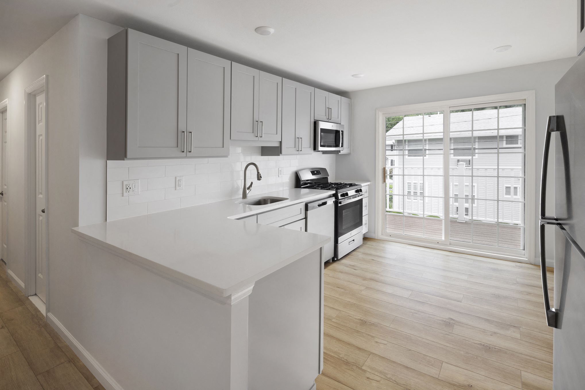 Image of kitchen with sliding doors leading to balcony