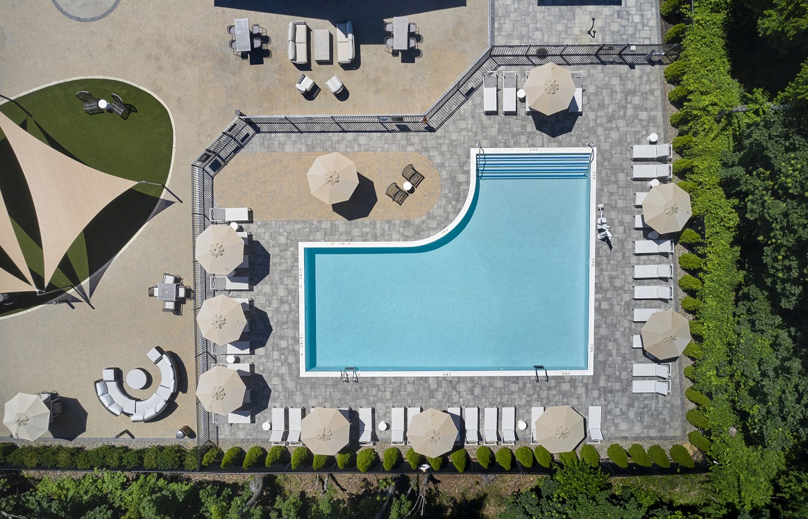 Image of pool deck with sun chairs