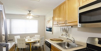 galley kitchen with dining tables and chairs at Heatherwood House at Ronkonkoma, Lake Ronkonkoma, NY, 11779 - Photo Gallery 6
