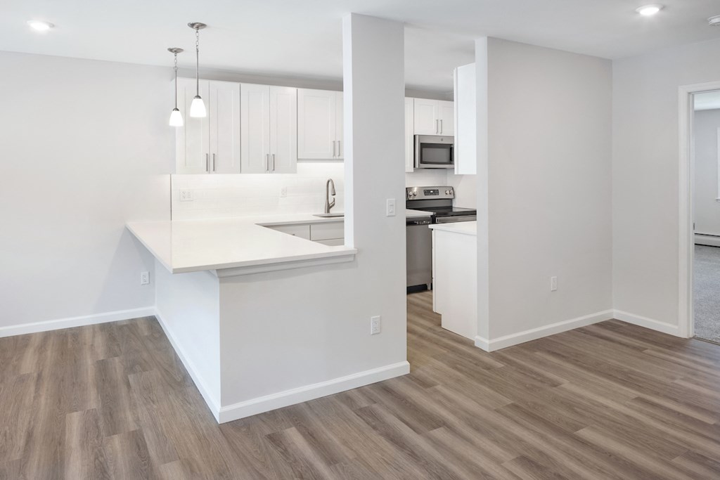 Wooden flooring Living room area with kitchen at Heritage Oyster Bay, East Norwich, NY