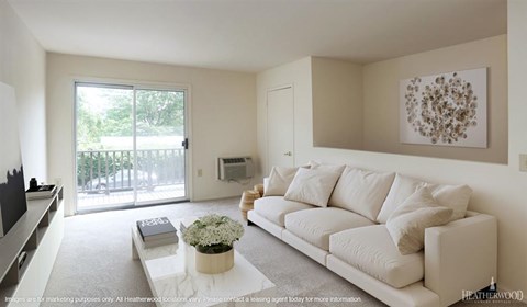 A living room with a white couch and a coffee table with flowers on it.