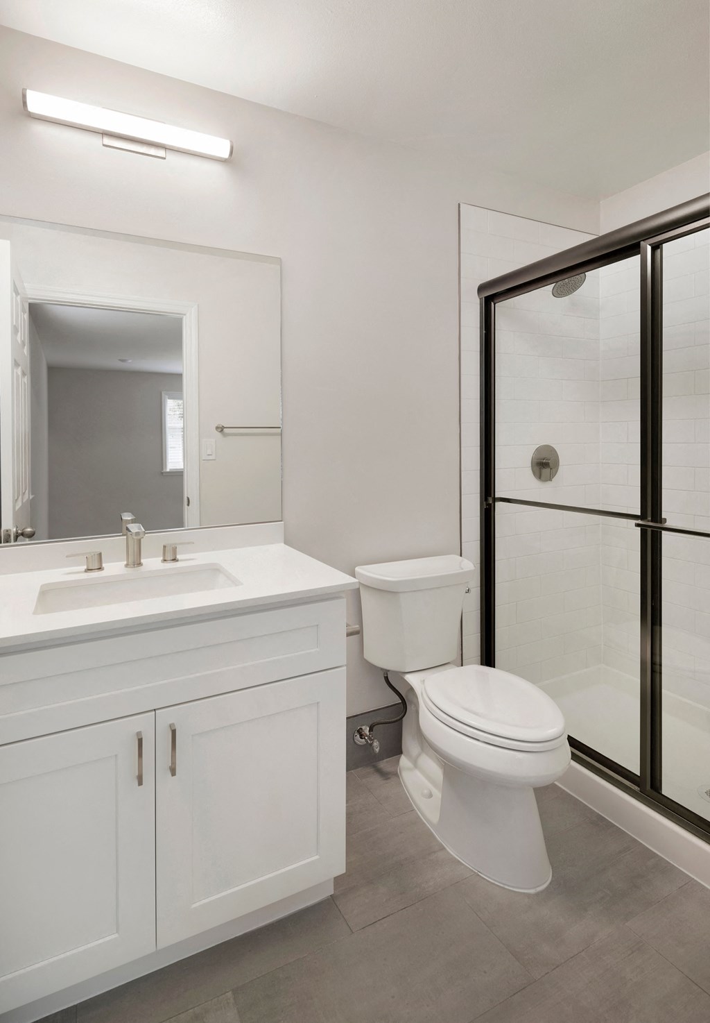 a white bathroom with a shower toilet and sink