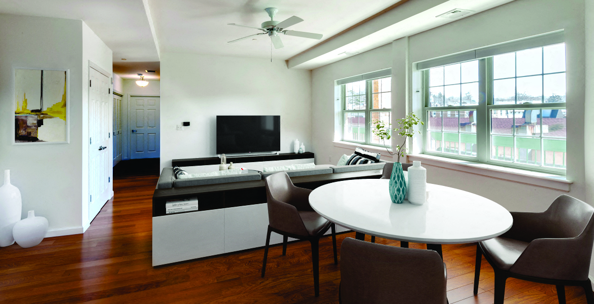 a living room with a table and chairs and a television