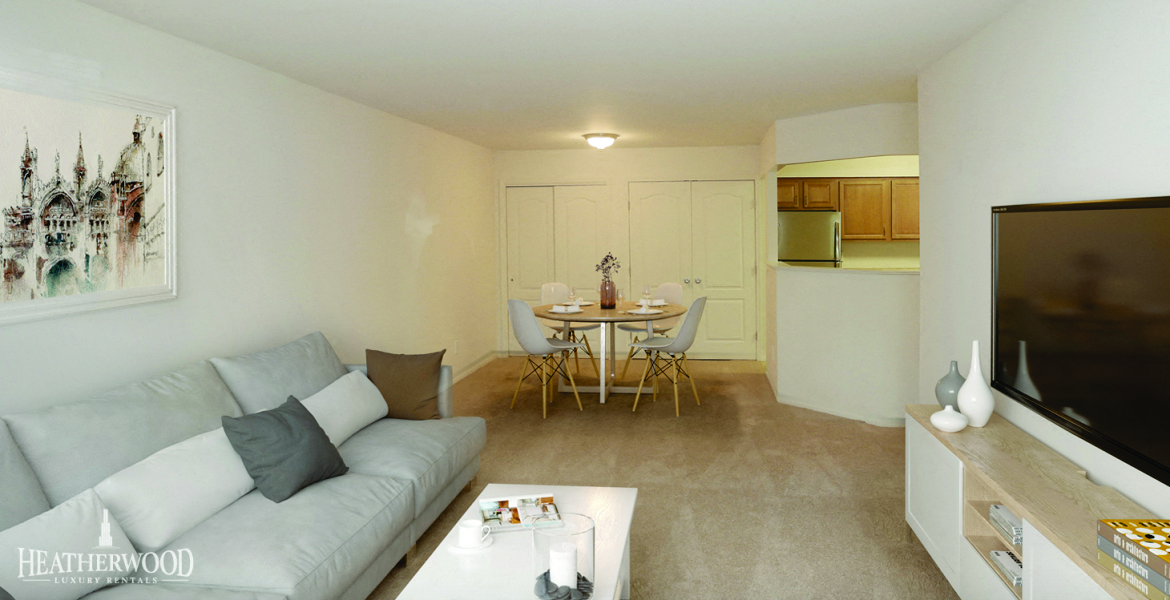living room set with dining room in background at Villas at Pine Hills, Manorville, NY
