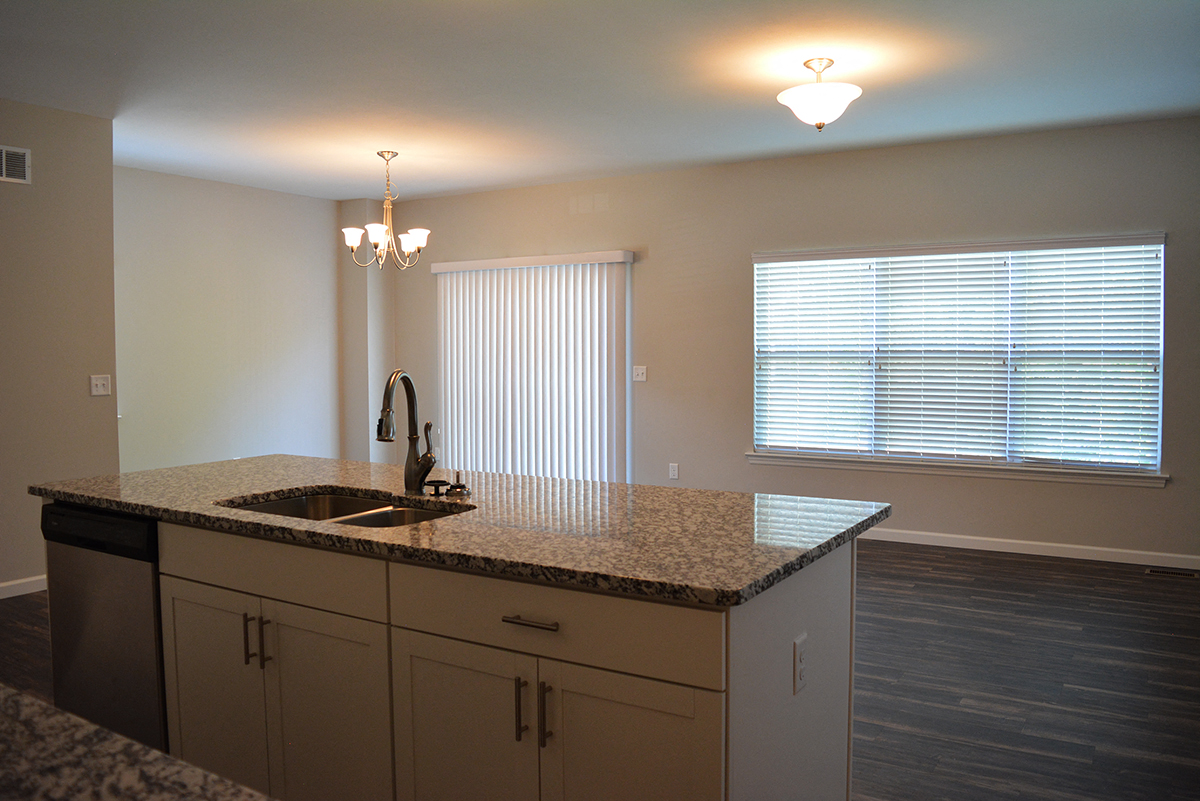 an empty kitchen with a sink and a window