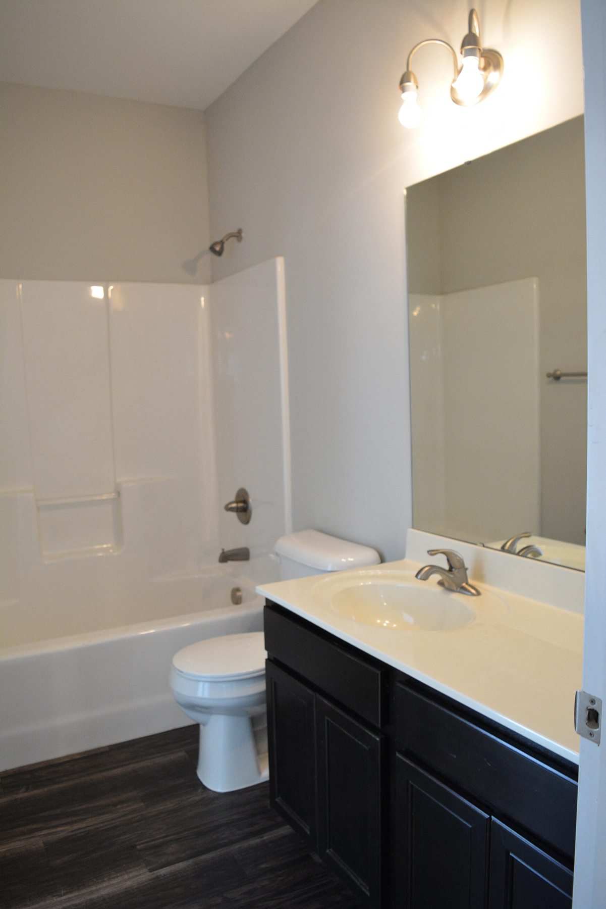 a bathroom with a toilet and a sink and a shower