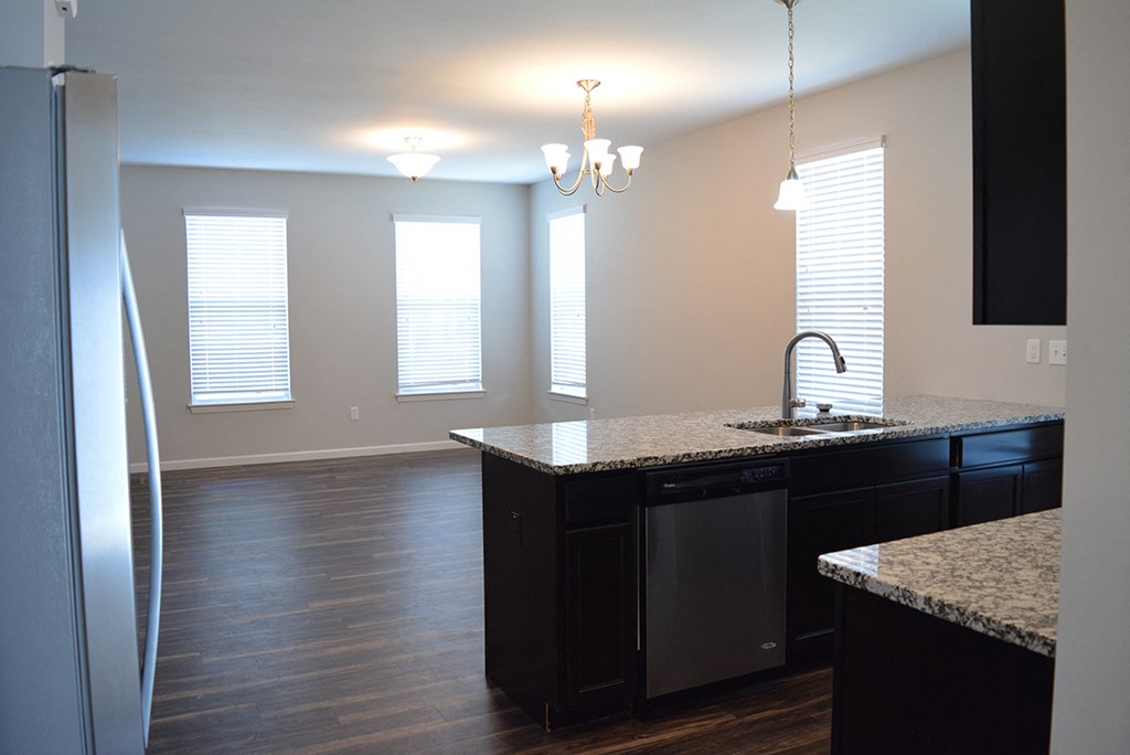 a view of a kitchen and living room from the center of the room