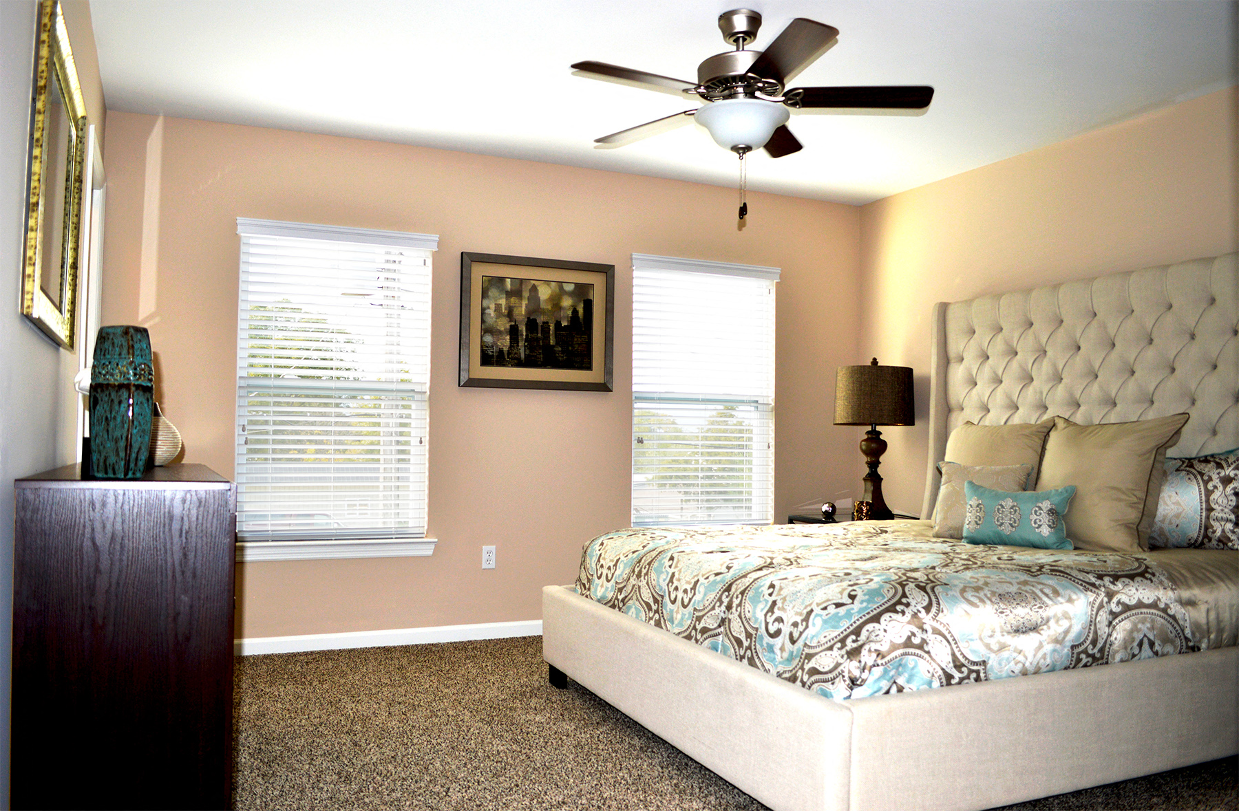 a bedroom with a bed and a ceiling fan