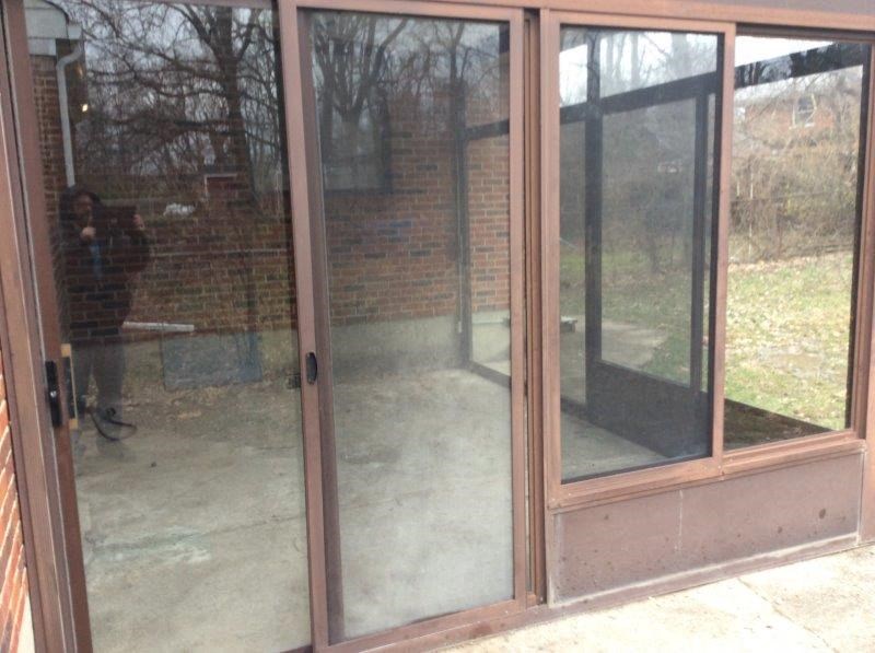 a room with a glass door and windows
