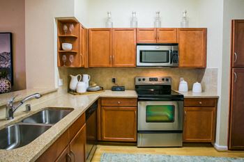 Full Gourmet Kitchens with Stainless Appliances and Cherry Maple Cabinetry at North Phoenix Apartment
