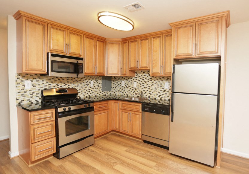 a kitchen with stainless steel appliances and wooden cabinets