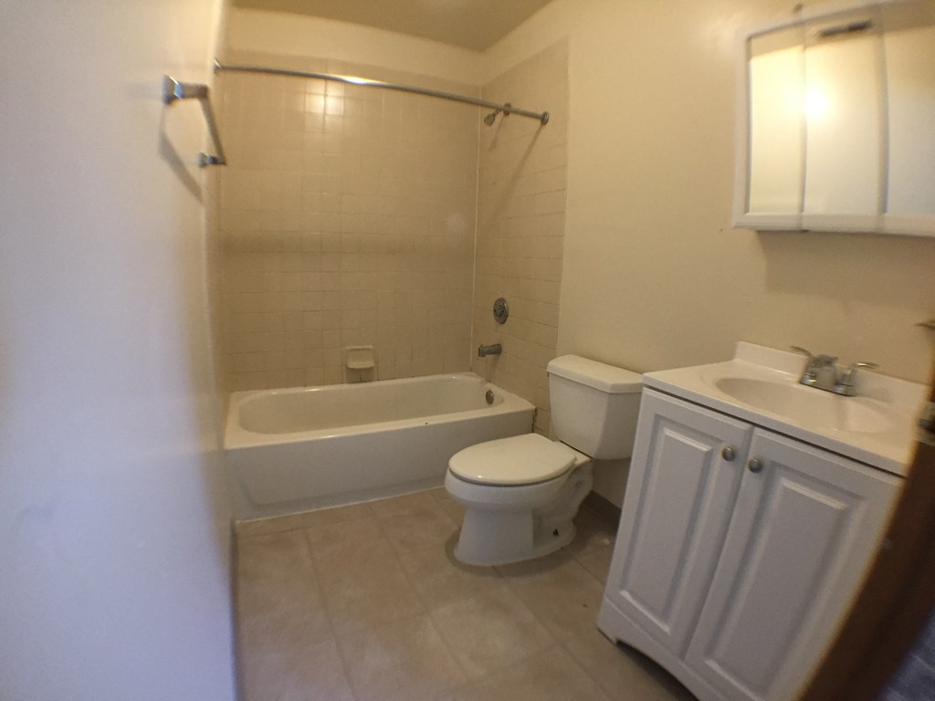 a small bathroom with a toilet and a tub and a sink