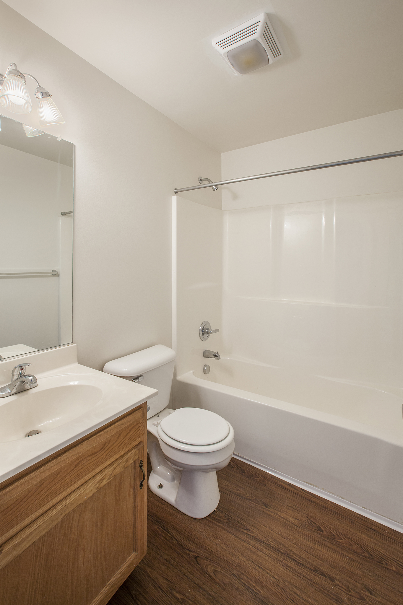 a bathroom with a toilet and a sink and a shower