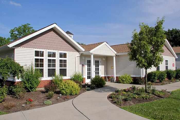 a white house with a sidewalk in front of it