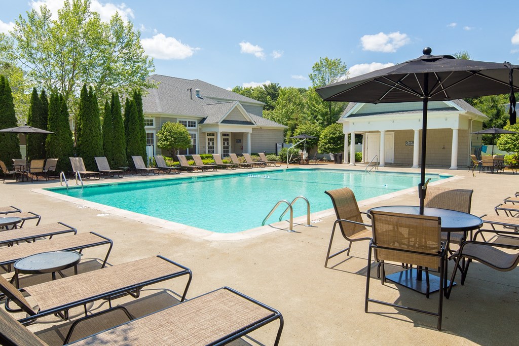 our apartments have a swimming pool with chairs and umbrellas