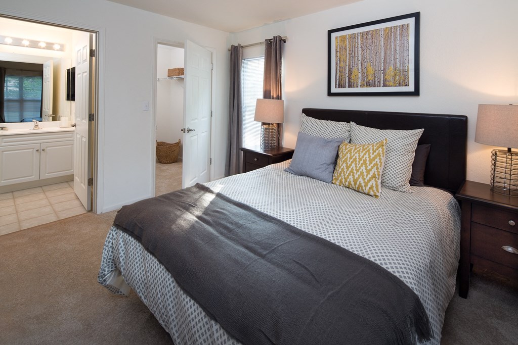 a bedroom with a large bed and a bathroom