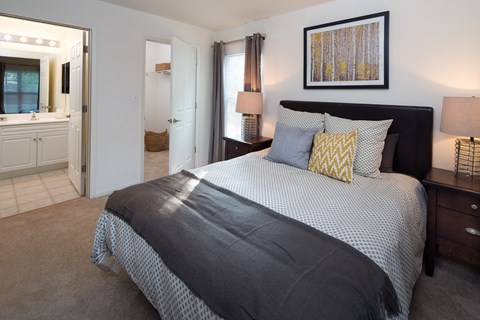 a bedroom with a large bed and a bathroom